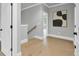 Bright hallway featuring hardwood floors, white trim, and an elegant piece of abstract art at 3745 Pilgrim Mill Rd, Cumming, GA 30041