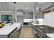 Open kitchen with gray cabinets, stainless steel appliances and a breakfast bar island at 3745 Pilgrim Mill Rd, Cumming, GA 30041