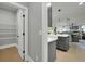 Gray kitchen island with white farmhouse sink, pendant lighting, and access to pantry and living areas at 3745 Pilgrim Mill Rd, Cumming, GA 30041