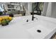 Close up of kitchen island sink with black faucet, quartz countertop, and living areas in the background at 3745 Pilgrim Mill Rd, Cumming, GA 30041