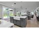 Open concept kitchen with gray island, farmhouse sink, pendant lighting and views of the living and dining areas at 3745 Pilgrim Mill Rd, Cumming, GA 30041
