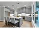 Bright kitchen with grey cabinets, quartz countertops, kitchen island and pendant lighting at 3745 Pilgrim Mill Rd, Cumming, GA 30041