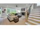 Inviting living room features a cozy fireplace, stairs, and a view of the backyard at 3745 Pilgrim Mill Rd, Cumming, GA 30041