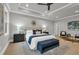 Main bedroom features a stylish bed, dark furniture, a modern ceiling fan and trey ceilings at 3745 Pilgrim Mill Rd, Cumming, GA 30041