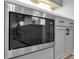 Close up of stainless steel microwave and modern gray cabinets at 3745 Pilgrim Mill Rd, Cumming, GA 30041