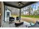 Covered back patio with seating, coffee table and view of the back yard at 3745 Pilgrim Mill Rd, Cumming, GA 30041