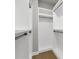 Well-lit walk-in closet with white shelving and wooden floor providing ample space for wardrobe storage at 3745 Pilgrim Mill Rd, Cumming, GA 30041