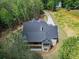 Bird's eye view of the back of the house, showing the rear balcony, patio, and surrounding trees at 3780 Tamiami Trl, Cumming, GA 30041