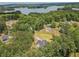 Wide aerial view of the property with lake views, adjacent houses, and a wooded area at 3780 Tamiami Trl, Cumming, GA 30041