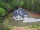 Picture of a modern home with gray shingles, landscaping and an attached garage at 3780 Tamiami Trl, Cumming, GA 30041
