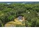 Stunning aerial view showcases the house amidst a serene forest landscape at 3780 Tamiami Trl, Cumming, GA 30041