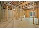 Unfinished basement with exposed framing, concrete floor, and walkout to the backyard at 3780 Tamiami Trl, Cumming, GA 30041
