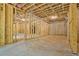 Unfinished basement with exposed wood framing, concrete walls and ceiling at 3780 Tamiami Trl, Cumming, GA 30041