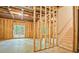 Unfinished basement with exposed wood framing and walkout to the backyard at 3780 Tamiami Trl, Cumming, GA 30041
