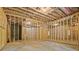 Unfinished basement with exposed framing and concrete floor at 3780 Tamiami Trl, Cumming, GA 30041