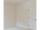 Neutral bedroom with white walls, carpet, and door; ready for personalization at 3780 Tamiami Trl, Cumming, GA 30041
