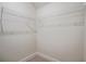 Empty closet with metal shelving and carpeted floor, ready to organize your wardrobe at 3780 Tamiami Trl, Cumming, GA 30041