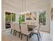 The dining room has a modern light fixture and large windows bringing in plenty of natural light at 3780 Tamiami Trl, Cumming, GA 30041