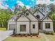 Charming two-story home with white siding, grey trim, and a landscaped yard at 3780 Tamiami Trl, Cumming, GA 30041