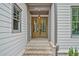 Elegant front entry featuring double doors, brick steps, and classic sidelights at 3780 Tamiami Trl, Cumming, GA 30041