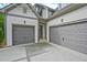Spacious three car garage with gray doors, attached to the main house at 3780 Tamiami Trl, Cumming, GA 30041