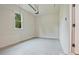 Bright and clean garage with concrete floor, overhead lighting, and single window at 3780 Tamiami Trl, Cumming, GA 30041