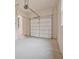 Spacious garage with door, steps to an entry door, and overhead door opener at 3780 Tamiami Trl, Cumming, GA 30041