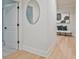 Hallway with hardwood floors, a bench, and contemporary decor at 3780 Tamiami Trl, Cumming, GA 30041