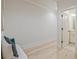 Hallway leading to a bathroom with a view of a bench with pillows at 3780 Tamiami Trl, Cumming, GA 30041