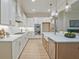 The kitchen features a center island, stainless appliances, and white cabinets at 3780 Tamiami Trl, Cumming, GA 30041