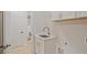 Bright laundry room featuring a sink, white cabinets, and lots of storage space at 3780 Tamiami Trl, Cumming, GA 30041