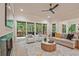 Bright living room featuring a ceiling fan, fireplace, and sliding doors to the outside deck at 3780 Tamiami Trl, Cumming, GA 30041