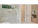 Bright main bathroom featuring marble shower with natural light and access to toilet at 3780 Tamiami Trl, Cumming, GA 30041