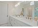 Bright main bathroom featuring marble floors, double vanities, with bright gold hardware at 3780 Tamiami Trl, Cumming, GA 30041