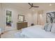 Bright main bedroom featuring hardwood floors, modern ceiling fan, deck access, and ensuite bathroom at 3780 Tamiami Trl, Cumming, GA 30041