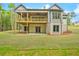 Stunning home features a spacious covered deck, walk out basement and a well-manicured lawn at 3780 Tamiami Trl, Cumming, GA 30041