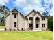 Charming brick home featuring a manicured lawn, traditional architecture, and a welcoming entrance at 5390 Deer Run Dr, Conyers, GA 30094