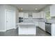 Modern kitchen with stainless steel appliances, island, and granite countertops at 5390 Deer Run Dr, Conyers, GA 30094
