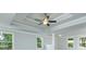 Living room with tray ceiling and large windows at 5390 Deer Run Dr, Conyers, GA 30094