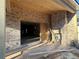 Covered patio with brick surround, a wood ceiling, and an opening to the home's interior at 157 Shadburn Ferry Rd, Buford, GA 30518
