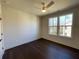 A well lit bedroom featuring dark hardwood floors and a modern ceiling fan at 160 Chiswick Cir, Alpharetta, GA 30009