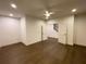 A bedroom with hardwood floors, two white doors, and a view of the staircase is presented at 160 Chiswick Cir, Alpharetta, GA 30009