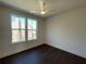 Bedroom featuring wood floors and bright windows showing the exterior at 160 Chiswick Cir, Alpharetta, GA 30009