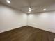 A well-lit bedroom featuring dark hardwood floors and a ceiling fan is displayed at 160 Chiswick Cir, Alpharetta, GA 30009