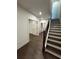Hallway featuring dark hardwood floors, white trim and doors, and stairs with dark handrail at 160 Chiswick Cir, Alpharetta, GA 30009