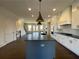 A kitchen with stainless steel appliances, a gray island, white cabinets, and dark countertops is shown at 160 Chiswick Cir, Alpharetta, GA 30009
