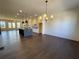 Open-concept living room and kitchen featuring hardwood floors, a fireplace, and a center island at 160 Chiswick Cir, Alpharetta, GA 30009
