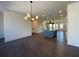 Open-concept living room with dark hardwood floors, modern lighting and a view of the kitchen and dining area at 160 Chiswick Cir, Alpharetta, GA 30009