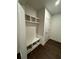 Mudroom featuring coat rack, bench, storage and a white door with hardwood floors at 160 Chiswick Cir, Alpharetta, GA 30009