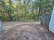 Natural backyard with surrounding trees and partially fenced perimeter at 6500 Wellington Chase Ct, Lithonia, GA 30058